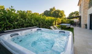 a hot tub sitting on top of a yard at Luxury Villa Aramis with jacuzzi in Malinska in Sveti Ivan