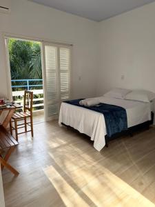 a bedroom with a bed and a sliding glass door at Lago Azul Acqua Park in Santo Cristo