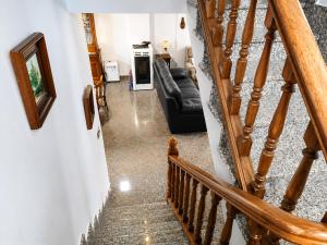 a stairway leading to a living room with a couch at Airtegal Casa da Praia Cedeira in Cedeira +11 photos