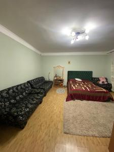 a living room with a couch and a bed at Літо in Bushtyno