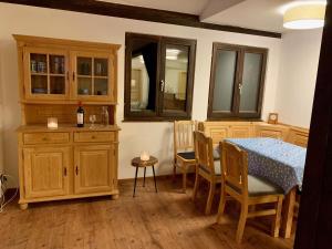 a kitchen with a table and chairs and a dining room at Ferienpark Vorauf Fepark 53 in Siegsdorf