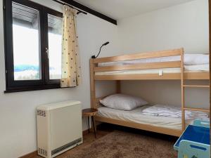 a bedroom with a bunk bed and a window at Ferienpark Vorauf Fepark 53 in Siegsdorf