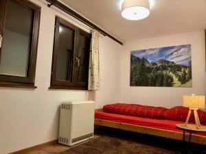 a room with a red couch and a window at Ferienpark Vorauf Fepark 53 in Siegsdorf