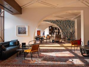 a living room with a couch and chairs at Rixos Tersane Istanbul in Istanbul
