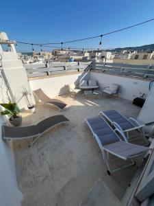 a balcony with lounge chairs and a view of the ocean at Gente di Mare Luxury Home in Fasano