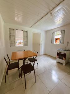 a dining room with a wooden table and chairs at Lago Azul Acqua Park in Santo Cristo