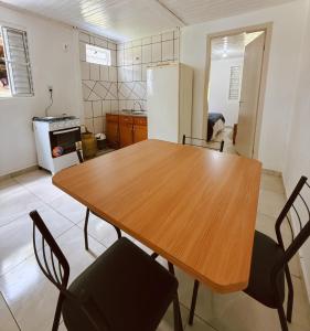 a kitchen with a wooden table and chairs at Lago Azul Acqua Park in Santo Cristo +11 photos