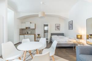 a bedroom with a bed and a table and chairs at cityswap- Wien 2 District in Vienna
