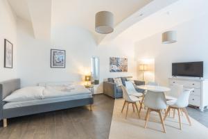 a living room with a bed and a table and chairs at cityswap- Wien 2 District in Vienna