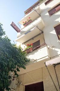 a building with potted plants on the balconies at Art Gallery Hotel Athens in Athens +36 photos