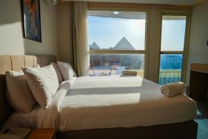 a bedroom with a large bed and a window at Pyramids Hostel in Cairo