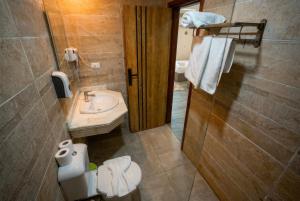a bathroom with a sink and a toilet and a mirror at Pyramids Hostel in Cairo +69 photos