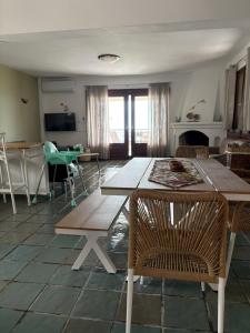 a living room with a wooden table and chairs at Aether House Αιθήρ in Toroni