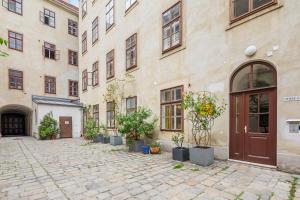 a courtyard with potted plants in front of a building at cityswap- Wien 2 District in Vienna