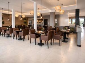 a dining room with tables and chairs in a restaurant at Hotel Cardal Tandil in Tandil