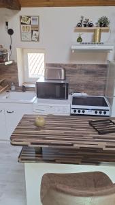 a kitchen with a stove and a counter top at La tête dans les étoiles - Appartement climatisé - 2 Chambres in Ruffec