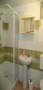 a bathroom with a glass shower and a sink at Pärlan 2 in Balatonboglár