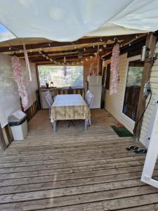 a patio with a table and chairs on it at Camping les cigales 5 étoiles in Le Muy