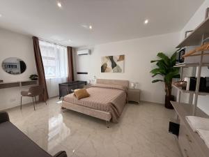 a bedroom with a large bed in a room at La dimora del duomo boutique suites & rooms in Terrasini