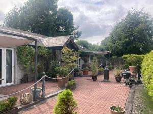 a garden with a brick patio with potted plants at Ballybur Lodge Mews 2 in Kilkenny