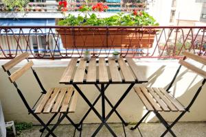 a table and two chairs on a balcony with a plant at Art Gallery Hotel Athens in Athens