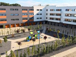 an apartment building with a playground in front of it at Apartament Lniany in Leszno