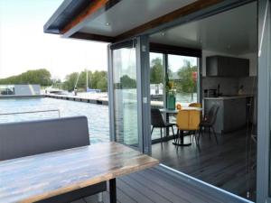 a kitchen and dining area of a house with a view of the water at Boot zonder naam in Volendam