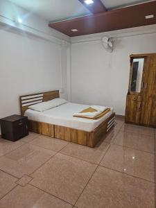 a bedroom with a bed in a room with a door at Relaxinn Dwaraka in Mānantoddy
