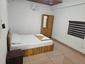 a small bedroom with a bed and a window at Relaxinn Dwaraka in Mānantoddy