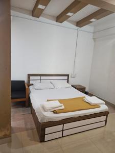 a bedroom with a large bed with a wooden headboard at Relaxinn Dwaraka in Mānantoddy