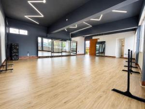 a large room with a wooden floor and blue walls at Hotel Illariy Wasi in Arica