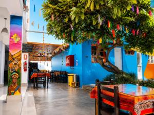 a dining room with a blue wall and a tree at Hotel Illariy Wasi in Arica +17 photos
