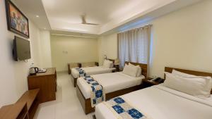 a hotel room with two beds and a television at Hotel The Grand Hyatt Dhaka in Dhaka