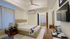 a bedroom with a bed and a flat screen tv at Hotel The Grand Hyatt Dhaka in Dhaka +46 photos