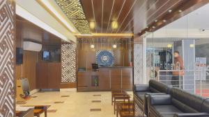 a lobby of a restaurant with a couch and chairs at Hotel The Grand Hyatt Dhaka in Dhaka