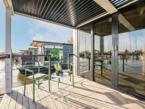 a patio with a table and chairs on a dock at Marina Sunrise in Volendam