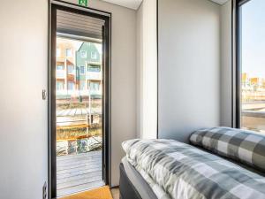 a room with a sliding glass door to a balcony at Marina Sunrise in Volendam