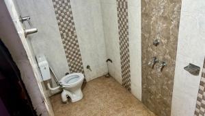 a bathroom with a toilet in a stall at RR palace in Pachmarhī