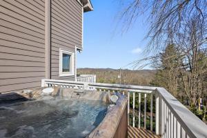 a hot tub on the balcony of a house at A Place Apart in Blowing Rock