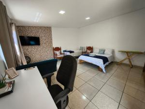 a room with a bedroom with a bed and a couch at Loft Carminatti in Cacoal