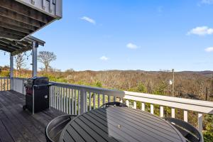 a table and chairs on the deck of a house at A Place Apart in Blowing Rock +20 photos