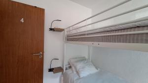 a bedroom with a bunk bed with two lamps at Pescadores GuestHouse in Costa da Caparica
