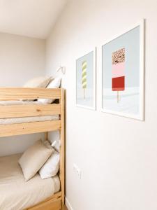 a bedroom with a bunk bed and two pictures on the wall at Airtegal Dunas de Cedeira in Cedeira