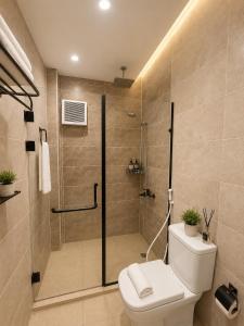 a bathroom with a shower with a toilet and a glass shower stall at Sun Hotel in Cairo