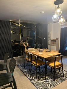 a dining room with a wooden table and chairs at La villa d'Isalya in Sainte-Suzanne +1 photo