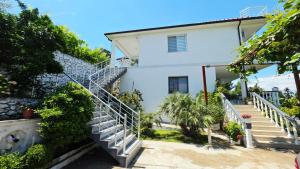 a house with stairs leading up to it at Selimi House in Shirokë