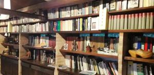 a book shelf filled with lots of books at Barbagianni in Senigallia +24 photos