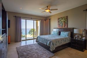a bedroom with a bed and a window with the ocean at Views to El Arco, Famous Cabo San Lucas bay rock formation in El Pueblito