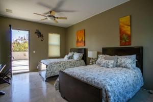 a bedroom with two beds and a ceiling fan at Views to El Arco, Famous Cabo San Lucas bay rock formation in El Pueblito