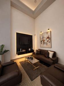 a living room with two couches and a flat screen tv at HOTEL RIVERA CENTRAL in Bucaramanga